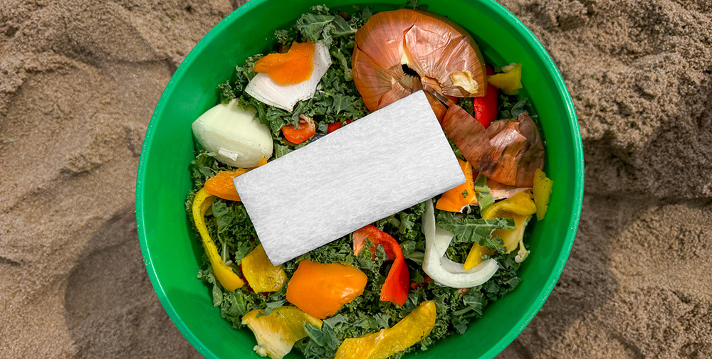 A rectangle of packing foam on a bed of food scraps.