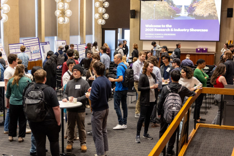 People standing and socializing in an event hall.