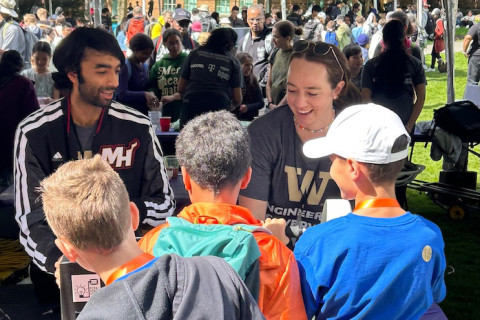 Hareesh Iyer at UW Engineering Discovery Days on May 3, 2024, helping run a booth for the Clean Energy Institute where he showed elementary and middle school students how advances in technology can improve efficiency and reduce energy usage.
