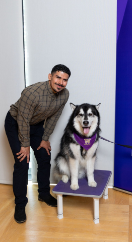 Danny Ayala Robles poses next to Dubs, UW's live husky mascot. 