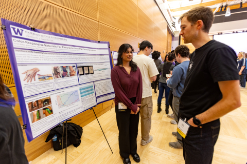 Graduate student Surbhi Kakar discusses her IV failure detection research with an attendee.