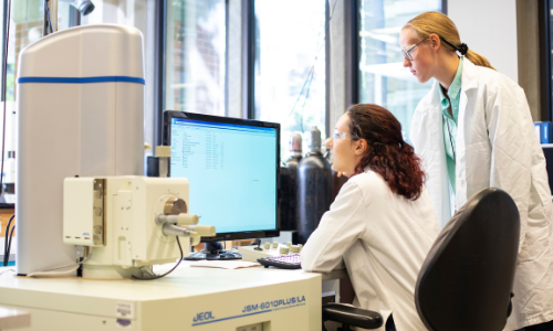 Two female materials scientists at a computer in the MSE lab