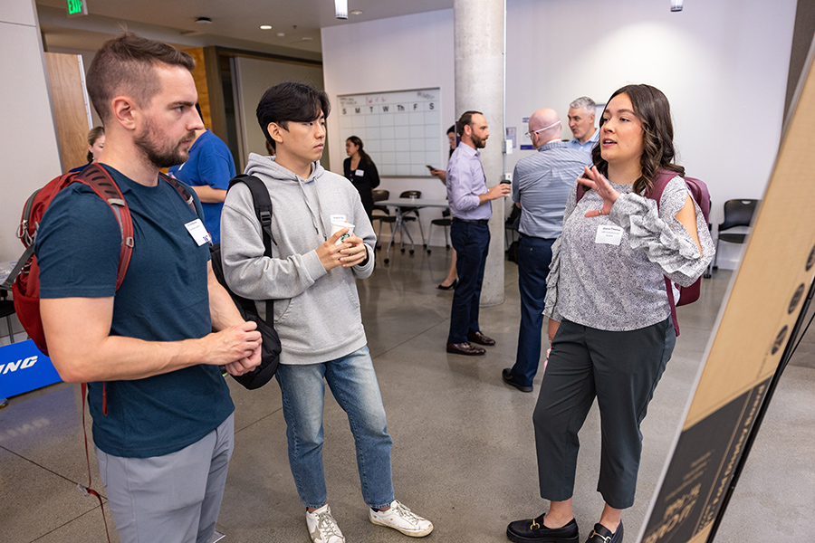 Senior Areesa Trevino presents a research poster to fellow attendees of the 2022 Research & Industry Showcase