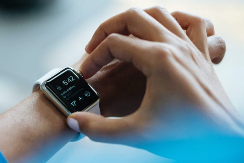 Close-up image of a hand checking activity statistics on a smart watch