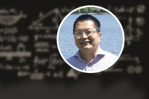 MSE professor Xiaodong Xu superimposed over a blurry blackboard with chalk diagrams and equations