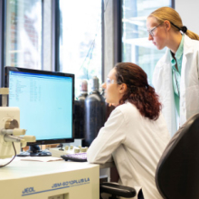 Two female materials scientists at a computer in the MSE lab